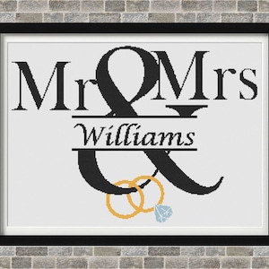 Könnte beinhalten: Schwarz-weißes Grafikdesign mit dem Text "Mr & Mrs Williams" und zwei goldenen Ringen mit einem Diamanten.