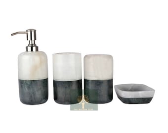 May include: A set of four bathroom accessories made of white and dark green marble. The set includes a soap dispenser, two tumblers, and a soap dish.
