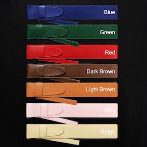 May include: A collection of colorful leather belts in various shades, including blue, green, red, dark brown, light brown, pink, and beige. Each belt features a matching buckle and strap, with the color names labeled on the image.