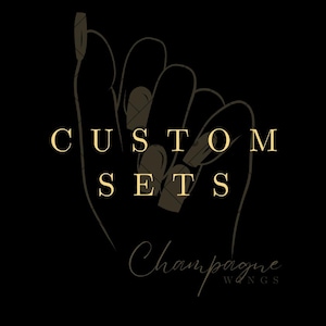 May include: A black and gold logo featuring a hand holding a set of acrylic nails. The text reads "CUSTOM SETS Champagne Wings".