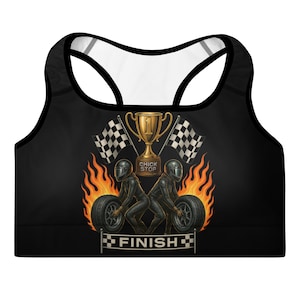 May include: Black sports bra with a racer design. The graphic features two racers, a trophy, checkered flags, and flames. The word "FINISH" is displayed at the bottom. The bra has a racerback design with a black trim and white interior.