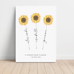 May include: A white canvas print featuring three watercolor sunflowers with the names Alexander, Isabella, and Gianna written below each flower. The text "IF FRIENDS WERE FLOWERS, I'D PICK YOU" is at the bottom.