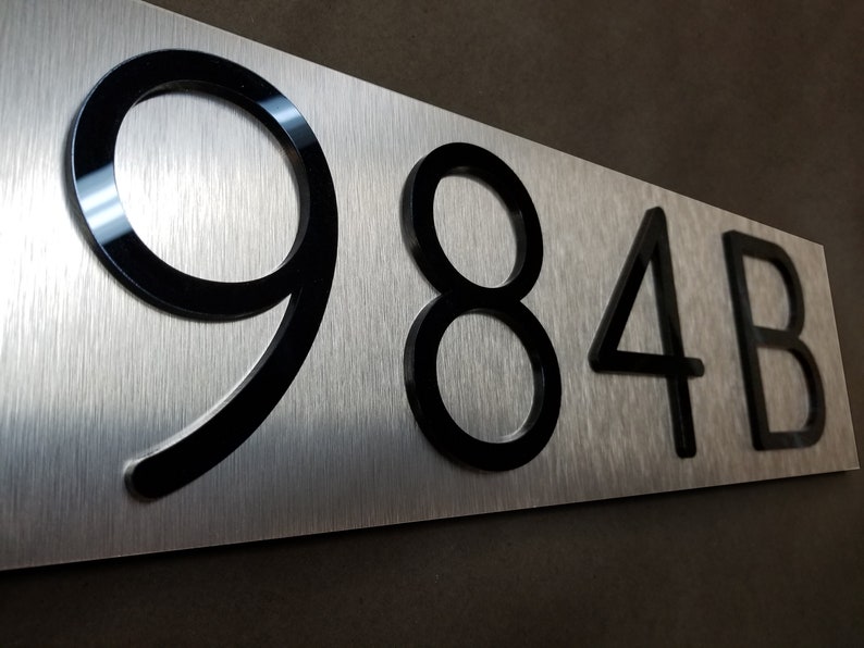Silver Horizontal house numbers plaque demonstrating the durability of weatherproof and rustproof materials.