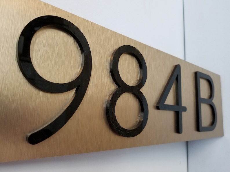 gold Horizontal house numbers plaque demonstrating the durability of weatherproof and rustproof materials.