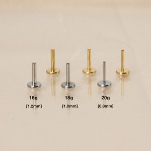 May include: Five surgical steel body jewelry studs in different sizes. The studs are 16g [1.2mm], 18g [1.0mm], and 20g [0.8mm].