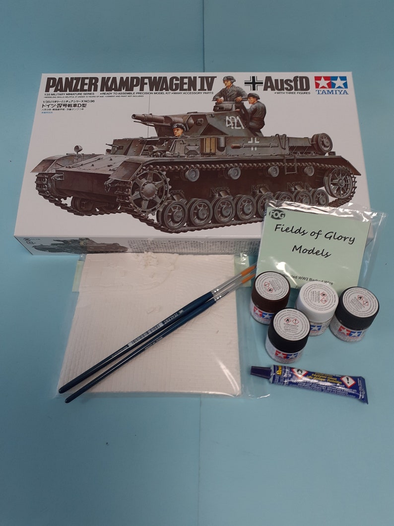 May include: A model kit of a German Panzerkampfwagen IV tank with Ausf D variant. The box art features a detailed illustration of the tank in a desert setting. The kit includes three figures, a Tamiya logo, and the words "Panzerkampfwagen IV + Ausf D".
