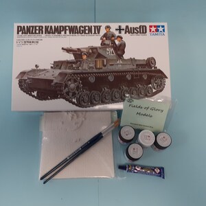 May include: A model kit box for a Panzerkampfwagen IV tank with Ausf.D, along with paint, glue, brushes, and sandpaper. The box is from Tamiya and features a detailed image of the tank.