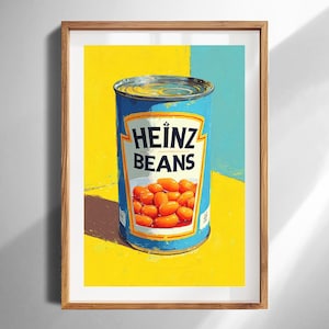 May include: A framed print featuring a vibrant illustration of a Heinz Beans can. The can is blue with the Heinz Beans logo and a depiction of baked beans. The background is a bright yellow and blue.