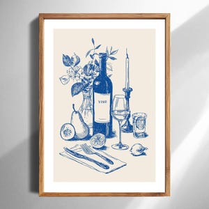 May include: A framed print featuring a blue ink illustration of a wine bottle labeled "VINO", a wine glass, a candle, fruit, and silverware. The artwork has a vintage, elegant feel, perfect for kitchen or dining room decor.