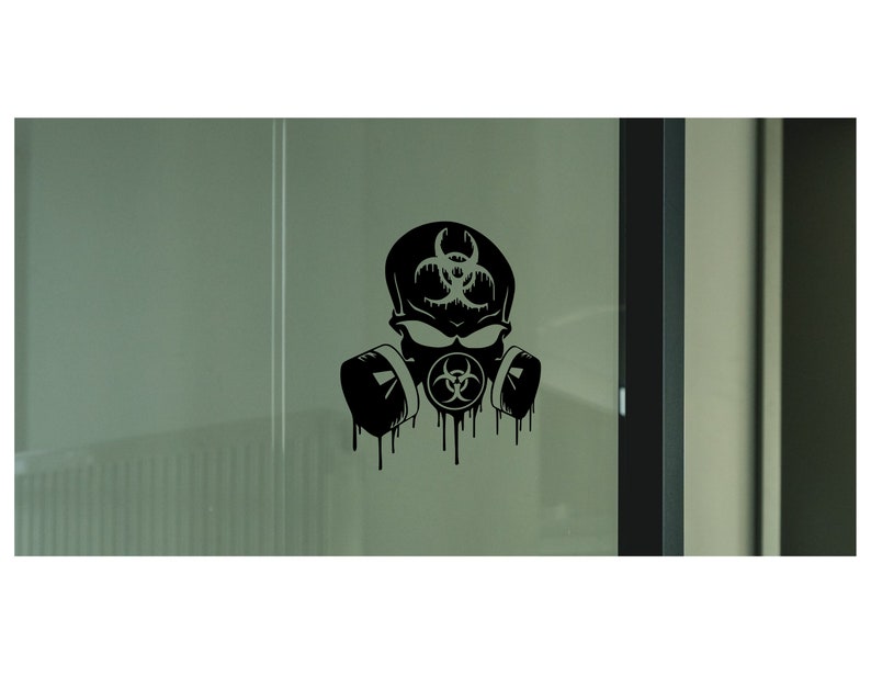 May include: Black and white sticker of a skull wearing a gas mask with a biohazard symbol on the mask. The sticker is on a glass door.