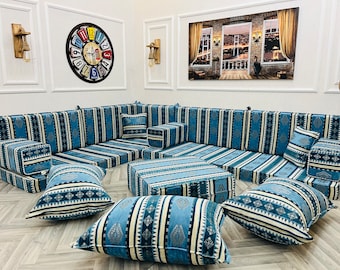May include: A blue and white striped sectional sofa with multiple cushions and a matching coffee table. The sofa is arranged in a U-shape and is perfect for a living room or family room.