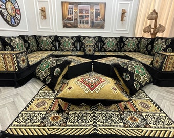 May include: A black and green patterned floor cushion set with a matching rug. The cushions are arranged in a U-shape and feature a geometric design. The rug has a similar pattern and is made of a soft, plush material.