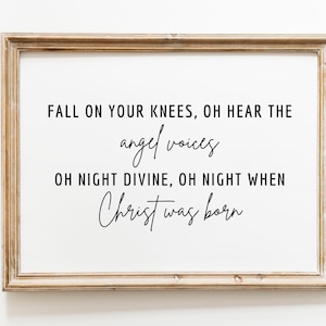 May include: A framed print with a white background and black text that reads "FALL ON YOUR KNEES, OH HEAR THE angel voices OH NIGHT DIVINE, OH NIGHT WHEN Christ was born".