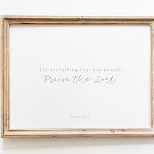 May include: A framed print with a white background and a black cursive quote: "Let everything that has breath praise the Lord." The quote is attributed to Psalm 150:6.