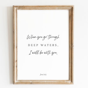 May include: A framed print with a white background and black text that reads "When you go through DEEP WATERS, I will be with you. Isaiah 43:2"