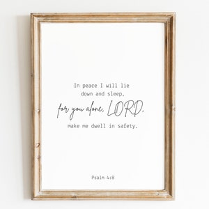 May include: A framed print with a white background and black text. The text reads "In peace I will lie down and sleep, for you alone, LORD. Make me dwell in safety. Psalm 4:8".