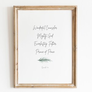 May include: A framed print with a white background and black text that reads "Wonderful Counselor, Mighty God, Everlasting Father, Prince of Peace" with a small green pine branch at the bottom. The text is from Isaiah 9:6.