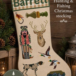 May include: A beige needlepoint Christmas stocking featuring the name Barrett in green on a tan and white checkered cuff. The stocking displays cross-stitched motifs including a fishing lure, a bottle, a nutcracker, a deer, ducks, a dog, and a fish.