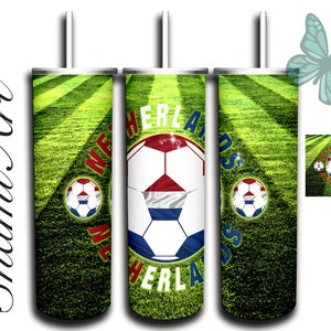 May include: Three stainless steel tumblers with a green grass and white lines background. Each tumbler has a soccer ball with the Dutch flag colors and the word "Netherlands" around the ball.