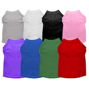 May include: Eight plain dog t-shirts in different colors: gray, white, black, pink, purple, blue, green, and red.