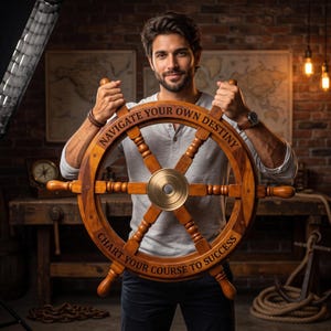 May include: A wooden ship wheel featuring a central brass hub and eight spokes. The rim is engraved with the text NAVIGATE YOUR OWN DESTINY and CHART YOUR COURSE TO SUCCESS. The wheel has a polished brown finish and a circular design.