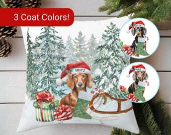 May include: A square throw pillow featuring a watercolor illustration of a dachshund wearing a red Santa hat labeled Fritz, sitting in a snowy forest with gifts, a wooden sled, and a green stocking. Two circular insets show dachshunds named Greta and Coco.