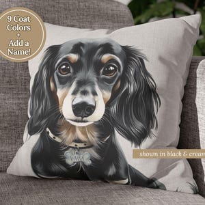 May include: A custom pillow featuring a black and tan dachshund with a name tag that reads "Daisy". The pillow is shown in black and cream with the text "9 Coat Colors + Add a Name!" in a brown circle.