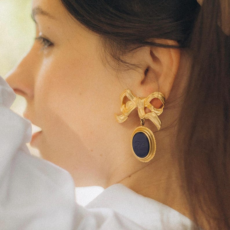 Vintage Karl Lagerfeld Bow Clip-On Earrings in Matte Gold with Navy Blue Logo Cabochon image 2