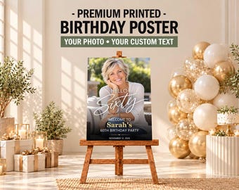 May include: A rectangular birthday poster on a wooden easel featuring a photograph of a smiling person with the text: PREMIUM PRINTED BIRTHDAY POSTER, YOUR PHOTO YOUR CUSTOM TEXT, HELLO SIXTY, WELCOME TO Sarah's 60TH BIRTHDAY PARTY, NOVEMBER 12, 2026.