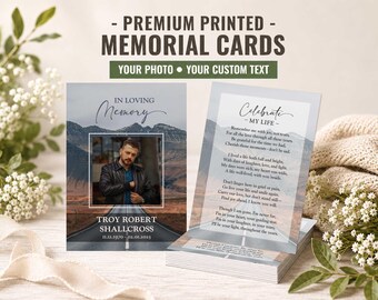 May include: Two rectangular memorial cards featuring a mountain road background. The left card displays a photo of a man, the text "IN LOVING MEMORY," a name, and dates. The right card features the text "Celebrate MY LIFE" and a poem.