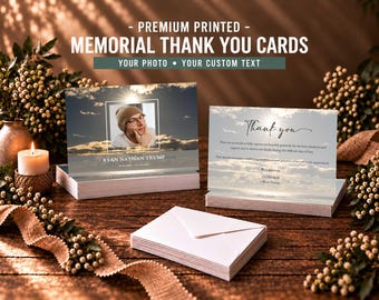 May include: Two rectangular memorial thank you cards featuring a sunset sky background. One card displays a portrait of a person in a beanie and glasses with the text RYAN NATHAN TRUMP. The other card shows the text Thank you and a message.