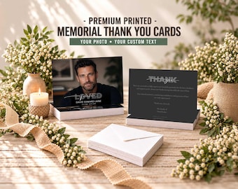 May include: A stack of rectangular memorial thank you cards featuring a portrait of a man on the front with the text LOVED and DAVID EDWARD LAINE, and a back side with the text THANK YOU and a printed message, accompanied by white envelopes.