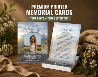 May include: Two rectangular memorial cards featuring a mountain landscape background. The left card displays a photo of a person, the text IN LOVING MEMORY, the name DANA LYNNE FORTESCUE, and dates. The right card shows the text Celebrate MY LIFE and a poem.