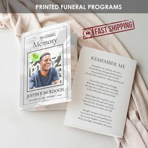 May include: Two funeral programs are displayed, one open and one closed. The closed program features a photo and the text "IN LOVING Memory" and the name "JUSTIN P. MURDOCH". The open program displays the poem "REMEMBER ME".