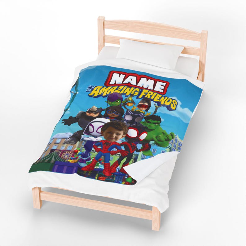 May include: A personalized blue blanket featuring a group of cartoon superheroes with the text "NAME His Amazing Friends". The blanket is on a wooden bed frame with a white pillow.