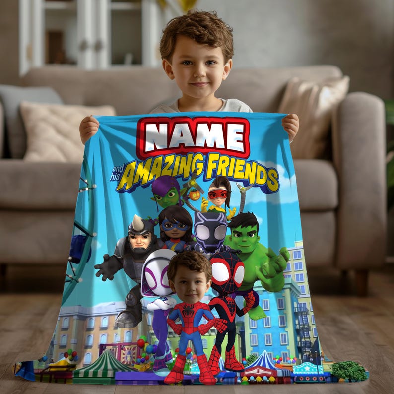 May include: A blue blanket featuring the text "NAME and his AMAZING FRIENDS" with cartoon superhero characters. The blanket is held by a young child. The blanket has a cityscape design at the bottom.