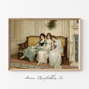 May include: Three women in elegant dresses sit on a gold and brown sofa in a room with white walls and a fireplace. The women are wearing green, white, and white dresses. The woman in the middle is wearing a necklace. There is a sprig of mistletoe hanging above the sofa.