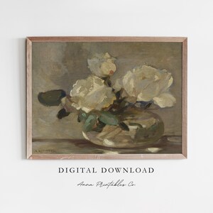 May include: A vintage painting of a bouquet of white roses in a clear glass vase. The painting is framed in a light wood frame and has a muted color palette.