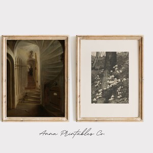 May include: Two framed prints, one with a painting of a spiral staircase in a dark hallway, and the other with a black and white photograph of a tree trunk with mushrooms growing at its base.