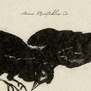 May include: Black and white illustration of a crow in flight. The crow is depicted in a simple, stylized manner, with its wings spread wide and its head turned to the side. The image is set against a light beige background. The text "Anna Printables Co." is visible at the top of the image.