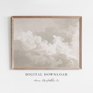May include: A digital download of a printable art print featuring a watercolor painting of clouds in shades of beige and gray. The print is framed in a light wood frame.