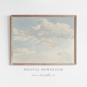 Puede incluir: Una descarga digital de una pintura de acuarela de un cielo nublado. El cielo es azul claro con nubes blancas. Las nubes son esponjosas y tienen una textura suave de acuarela. La pintura está enmarcada en un marco de madera claro.