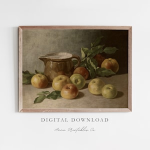 May include: A still life painting of a brown ceramic pitcher and a group of yellow apples with green leaves on a brown background.