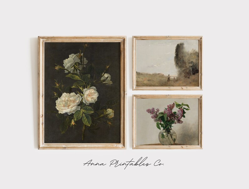 May include: Set of three framed vintage art prints featuring floral still life paintings. The first print shows a bouquet of white roses against a dark background. The second print shows a landscape scene with a figure walking in a field. The third print shows a bouquet of purple lilacs in a glass vase.