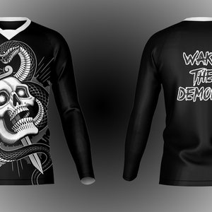 May include: Black long-sleeve shirt with a white skull and snake graphic on the front and the text "WAKE THE DEMONS" on the back.