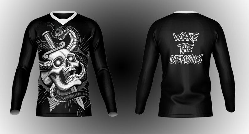 May include: Black long-sleeve shirt with a white skull and snake graphic on the front and the text "WAKE THE DEMONS" on the back.
