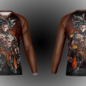 May include: A brown long-sleeve shirt with a black and orange graphic print of a character with spiky black hair. The character is wearing a black and orange suit with a yellow belt.