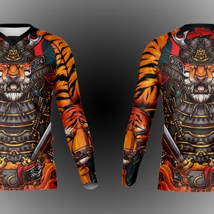 May include: A long-sleeved shirt with a tiger wearing samurai armor and holding swords. The shirt has a tiger stripe pattern in orange and black.