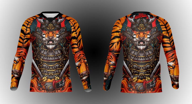 May include: A long-sleeved shirt with a tiger wearing samurai armor and holding swords. The shirt has a tiger stripe pattern in orange and black.
