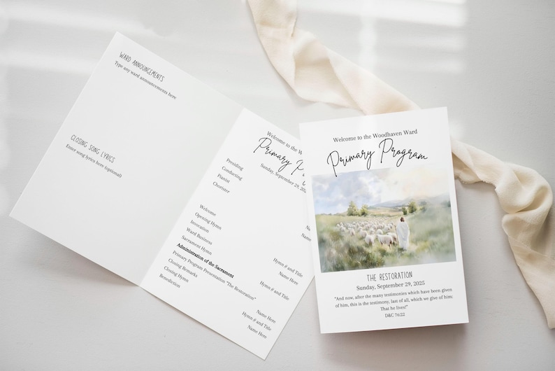 May include: White printed program for the Woodhaven Ward Primary Program. The program features a pastoral image and text, including "The Restoration" and the date. The program is open, revealing the inside contents.